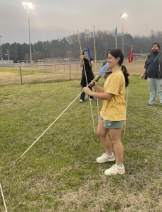 Student getting ready to throw a spear using an atl-atl spearthrower 