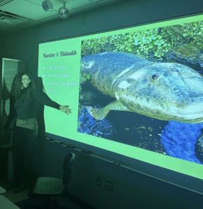 student giving demonstration using Powerpoint at an anthropology club event 